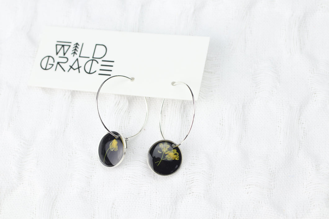 Silver Plated Hoops Mixed Botanicals atop Black Resin